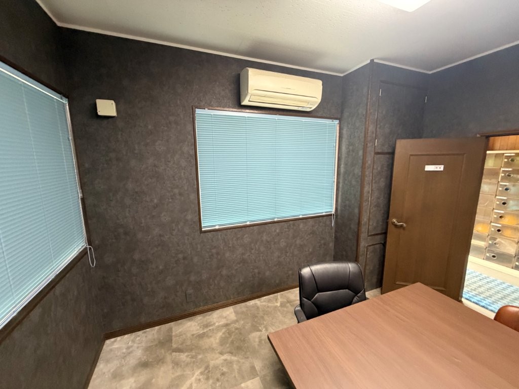 古河市の事務所会議室におけるクロス張替えとブラインド交換後の窓側壁面の仕上がり